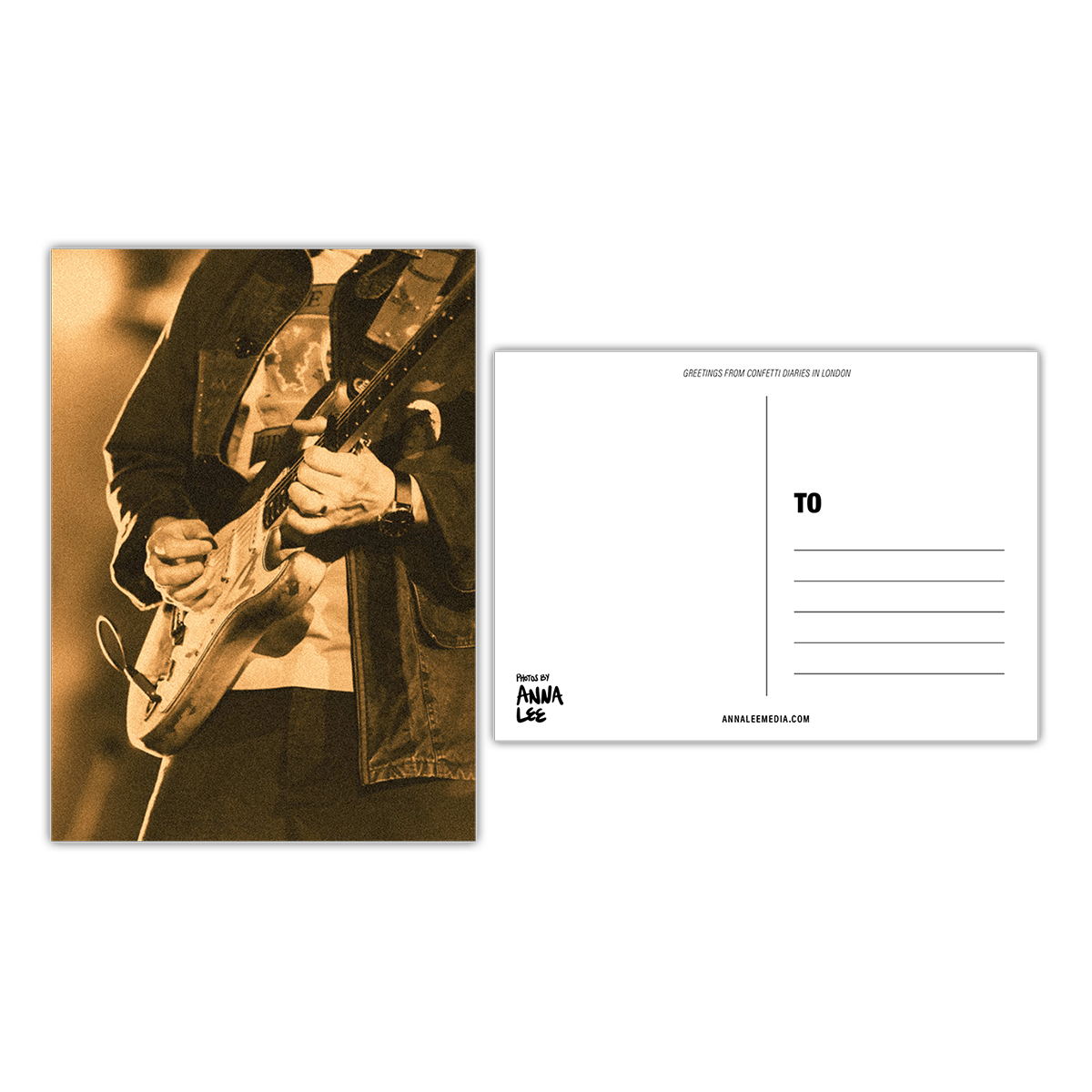 Side-by-side view of a postcard’s front and back. The front shows a close-up portrait of Jonny playing electric guitar, a plectrum in his right hand, and a cloud-like image on his shirt. The photo has a vintaged yellow wash. The back, in landscape, features a writing space on the left, address lines on the right, “GREETINGS FROM CONFETTI DIARIES IN LONDON” in sloped text at the top, “Photos by Anna Lee” in the bottom right, and “Annaleemedia.com” centered below.